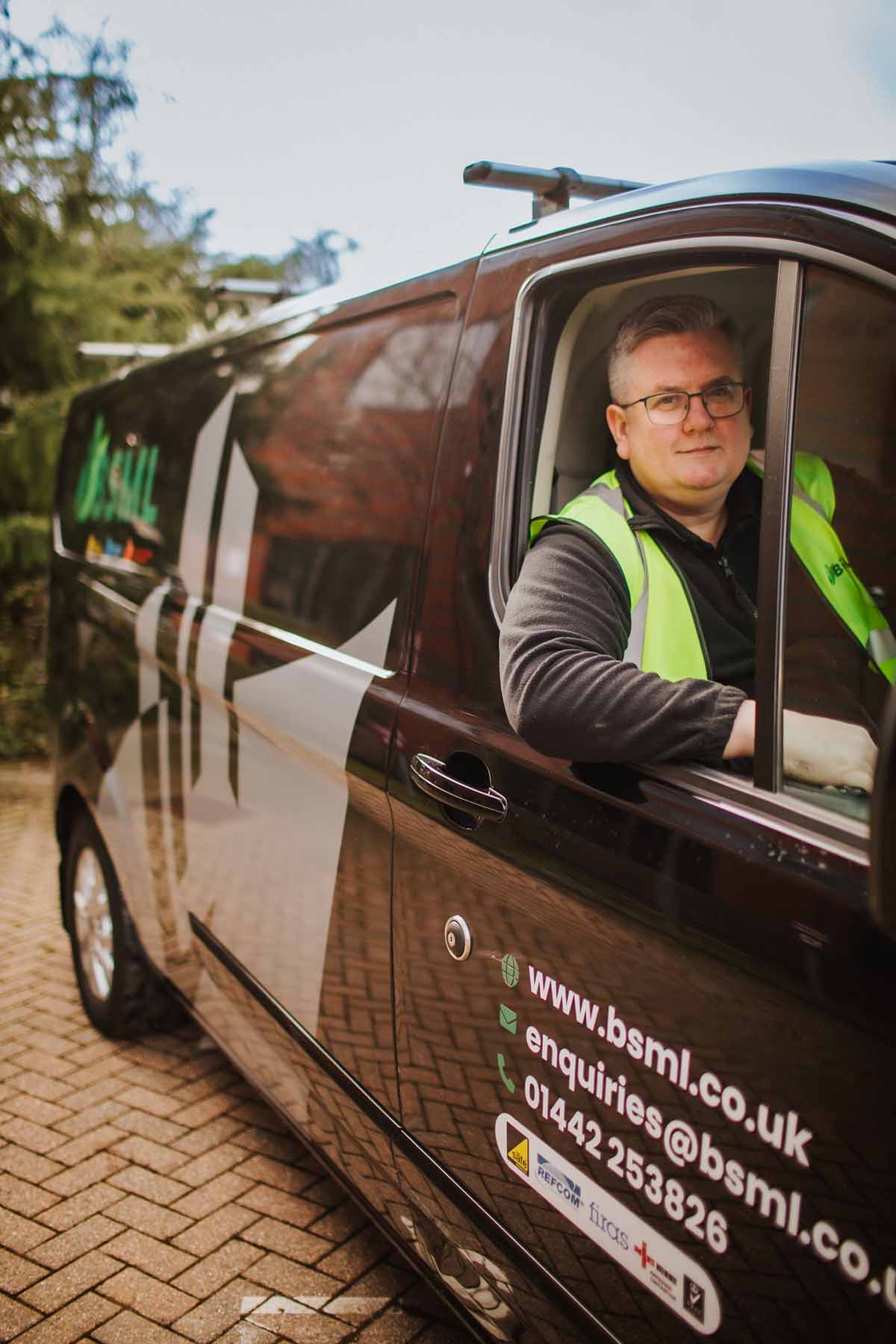 A man sitting proudly inside a BSML van